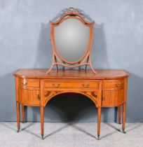 An Edwardian Satinwood and Inlaid Kneehole Dressing Table, with bowed ends, fitted three drawers and