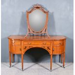 An Edwardian Satinwood and Inlaid Kneehole Dressing Table, with bowed ends, fitted three drawers and