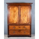 A George IV Gentleman's Mahogany Wardrobe, the whole decorated with reeded uprights and frieze