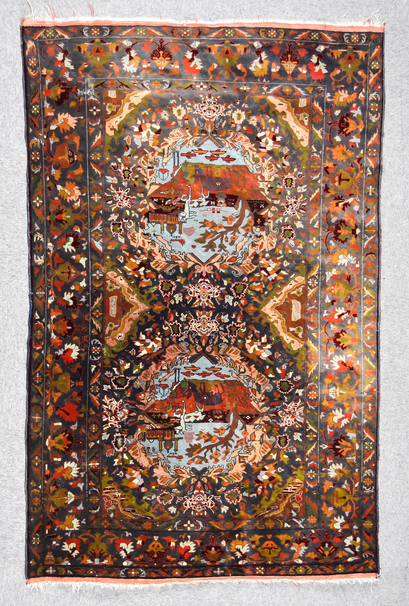 A 20th Century Anatolian Part Silk Picture Rug woven in colours of pale blue, fawn and wine, the