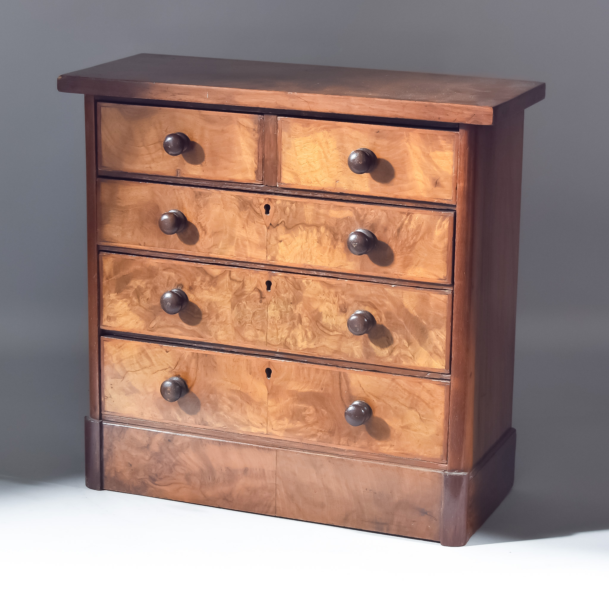 A Victorian Figured Walnut Miniature Chest, square edge to top with fitted two short and three long