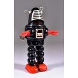 A Yoshiya, Japan, Tin Plate "Planet Robot", Circa 1960s, in black with red hands and feet, with key,