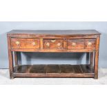 A Late 17th Century Panelled Oak Dresser Base, the three plank top with moulded edge, fitted three