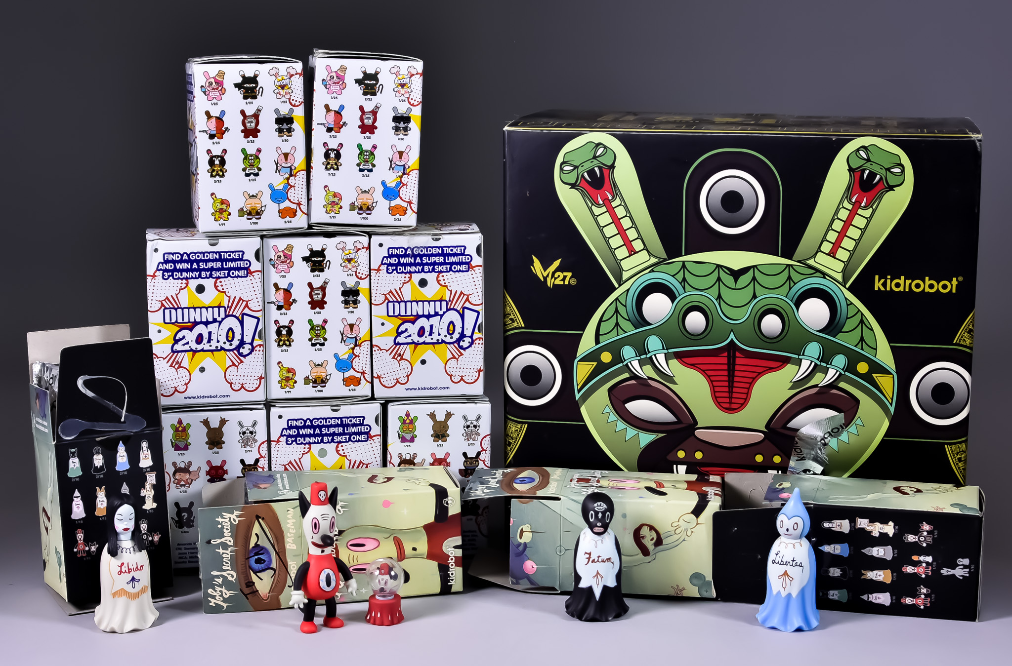 A Collection of Kidrobot Figures, comprising - an 8" Marka27, serpent dunny, four 3" Toby's Secret