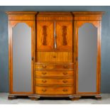 An Edwardian Satinwood and Inlaid Breakfront Wardrobe, with moulded cornice, fitted with three