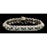 An 18ct White Gold Bracelet, set with small diamond and emerald stones, 190mm overall, gross