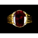 An 18ct Gold Faceted Ruby Ring, with fluted shank set with a faceted ruby stone, approximately