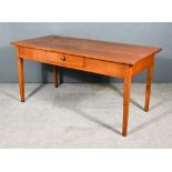 A 19th Century French Provincial Fruit Wood Kitchen Table, with three plank cleated top, fitted