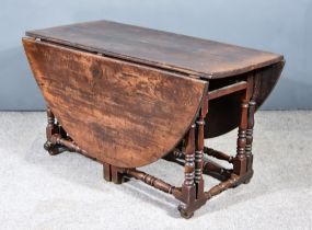 A 17th Century Oak Oval Gateleg Table with plain top, fitted one frieze drawer, on baluster-turned