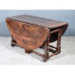 A 17th Century Oak Oval Gateleg Table with plain top, fitted one frieze drawer, on baluster-turned