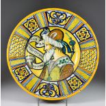 An Italian Maiolica Dish in the Deruta Style, Late 19th Century, the centre painted with the head of