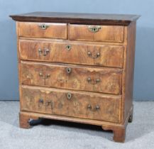 An 18th Century Walnut and Pine Sided Chest, pine top with moulded edge, the front inlaid with cross
