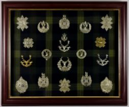 A Framed Collection of Scottish Regimental Cap Badges, on tartan background Note: Photographic