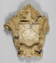 An English Marble Heraldic Achievement, 17th/18th Century, carved with shield surmounted by a dog