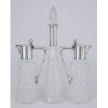 A Pair of German Silver Mounted and Cut Glass Claret Jugs and a Similar Decanter, the claret jugs