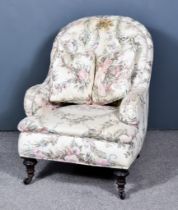 A Victorian Spoon Button Back Armchair, seat back and arms upholstered in floral patterned cloth and