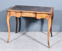 A Victorian Figured Walnut Writing Table, of shaped outline, with leather inset and moulded edge