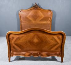 A Late 19th Century French Walnut and Kingwood 4ft 6ins Bedstead, the head board with leaf scroll