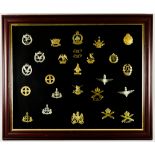 A Framed Collection of British Military Cap Badges, various regiments and arms, 26 in total Note: