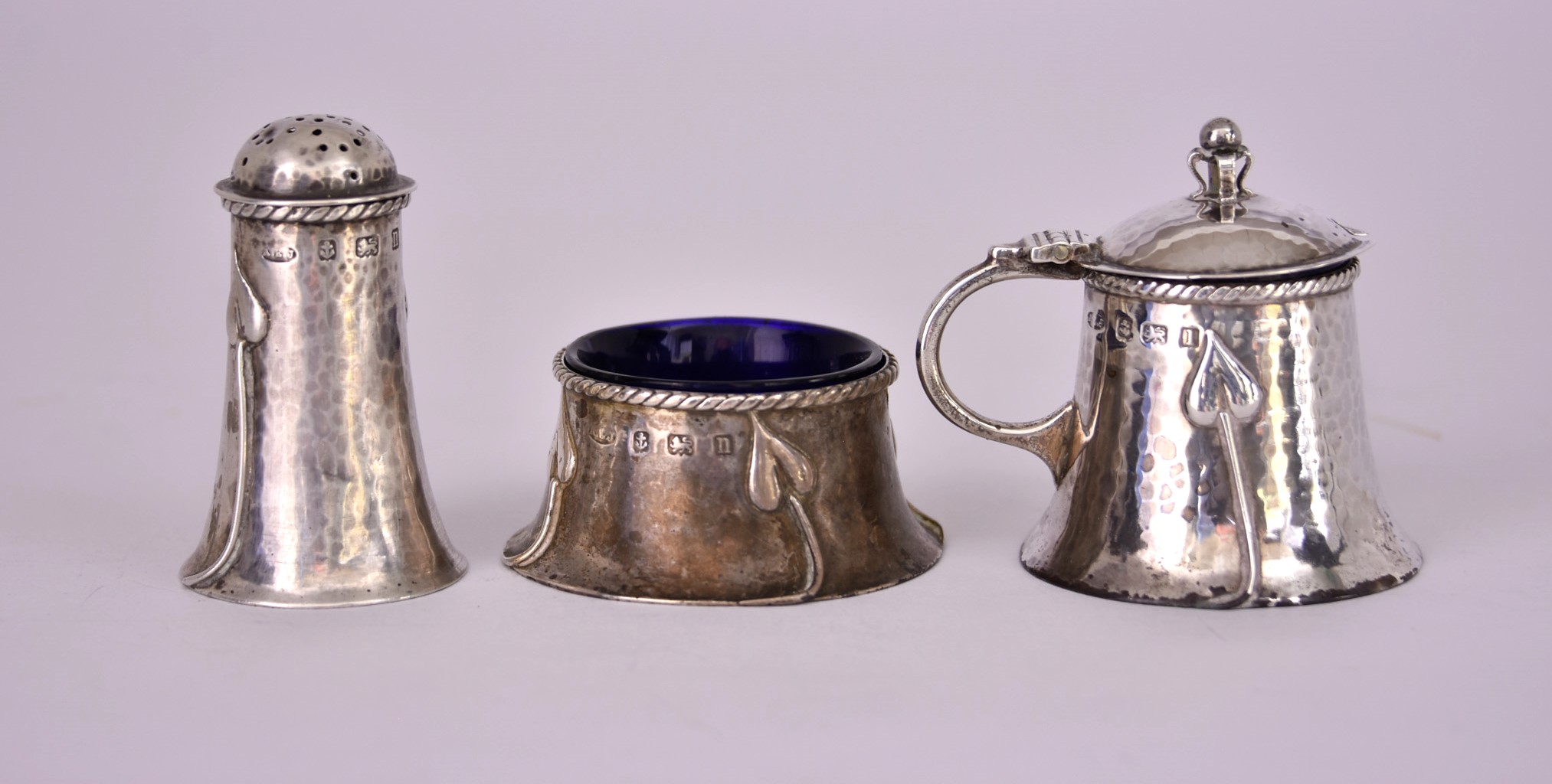 A George V Silver Arts and Crafts Three-Piece Condiment Set, by A.E. Jones, Birmingham 1912, of