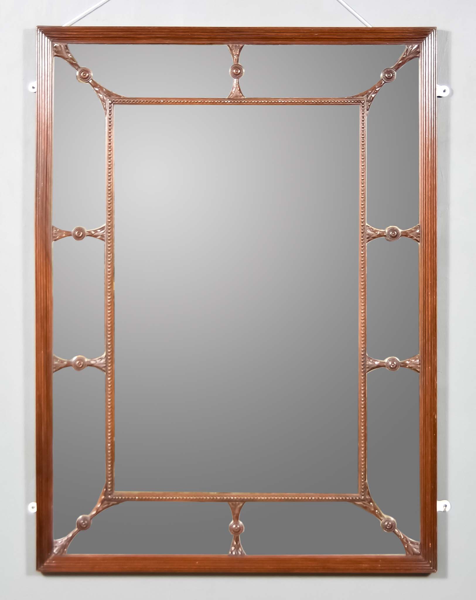 An Early Victorian Mahogany Wall Mirror, the frame with reeded, beaded and carved decoration, and