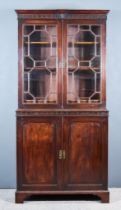 A George III Mahogany Bookcase, the upper part with moulded cornice, the frieze with blind fret