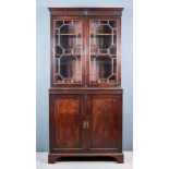 A George III Mahogany Bookcase, the upper part with moulded cornice, the frieze with blind fret