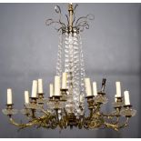 A Late 19th/Early 20th Century French Gilt Brass Eighteen Light Electrolier, mounted with glass