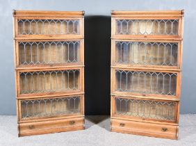 A Pair of Late 19th/Early 20th Century Oak Four Tier Sectional Bookcases, each tier enclosed by a