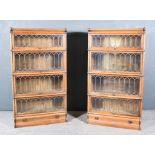 A Pair of Late 19th/Early 20th Century Oak Four Tier Sectional Bookcases, each tier enclosed by a