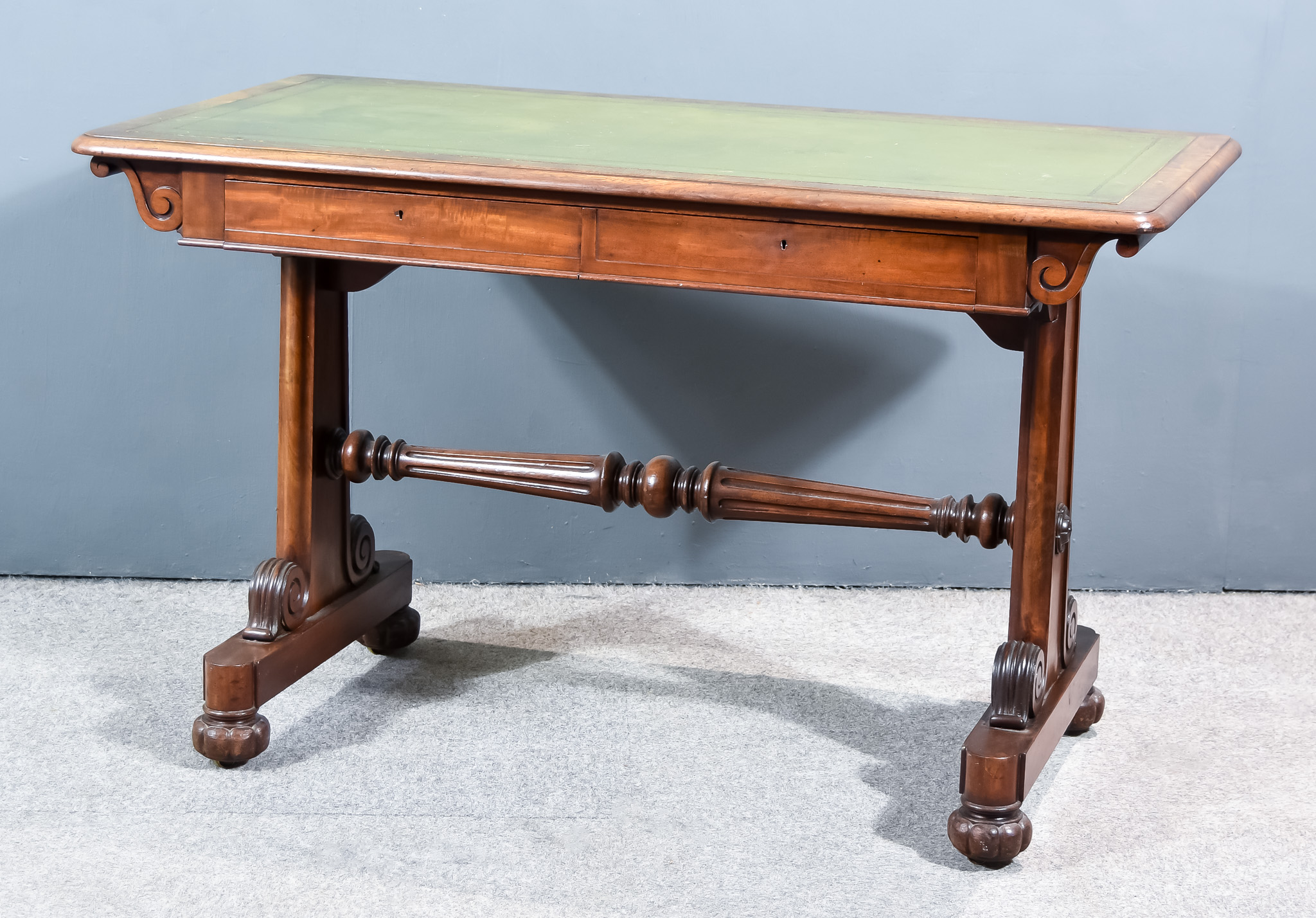 An Early Victorian Mahogany Library Table with green leather and gilt tooled inset and moulded