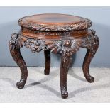 A Chinese Hardwood Circular Occasional Table, the whole boldly carved with stylised dragons and
