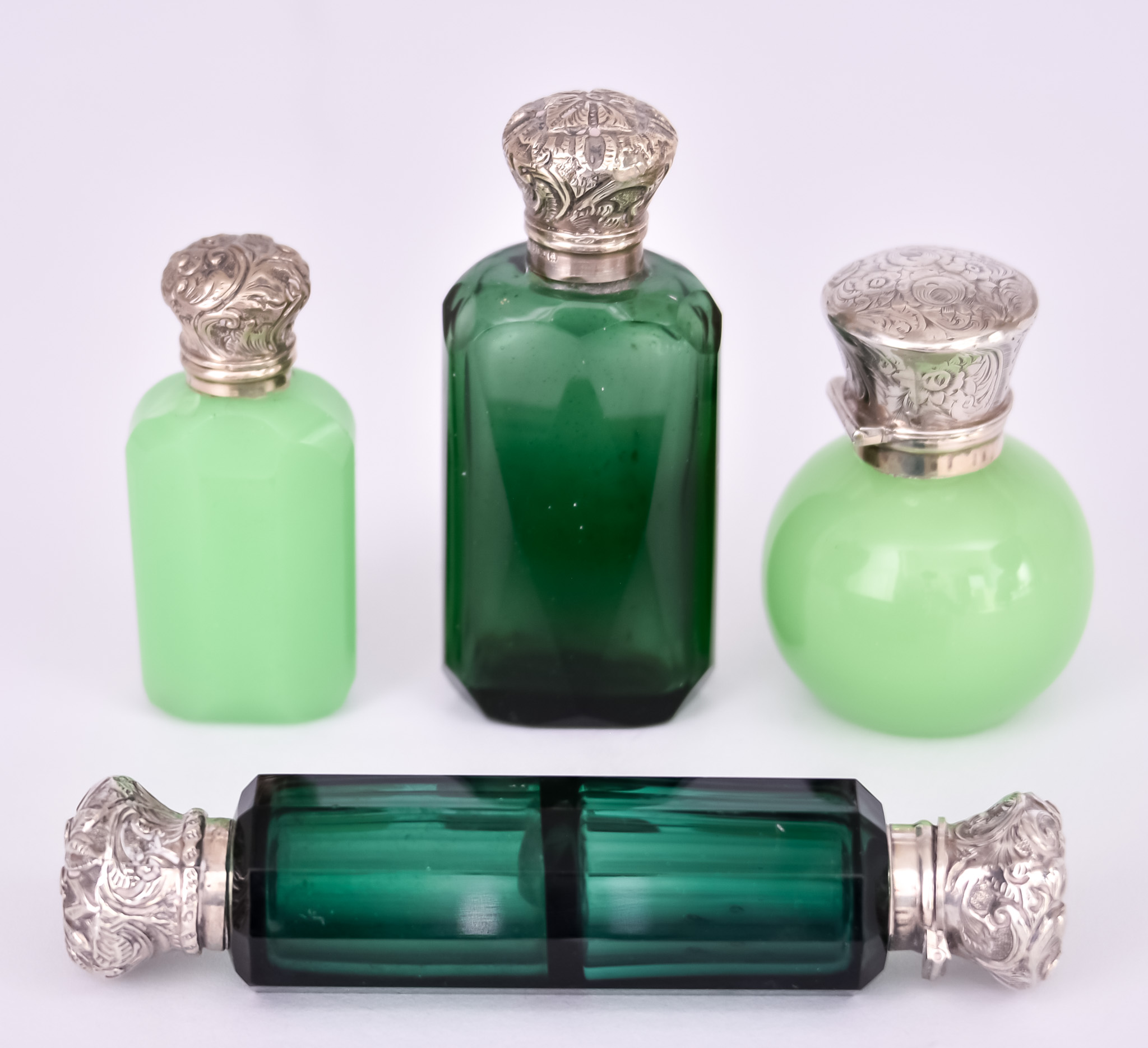 A Victorian Silver Mounted Green Glass Scent Bottle and Three Others, the faceted scent bottle by