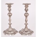 A Pair of George III Cast Silver Candlesticks by Ebenezer Coker, London 1766, with shell and gadroon