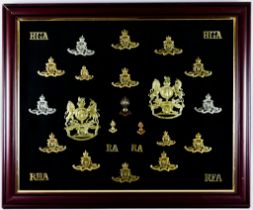 A Framed Collection of Cap Badges and Helmet Plates for the Royal Artillery Note: Photographic