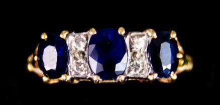 A 18ct Gold Sapphire and Diamond Ring, set with three synthetic sapphires, approximately 1.25ct