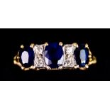 A 18ct Gold Sapphire and Diamond Ring, set with three synthetic sapphires, approximately 1.25ct