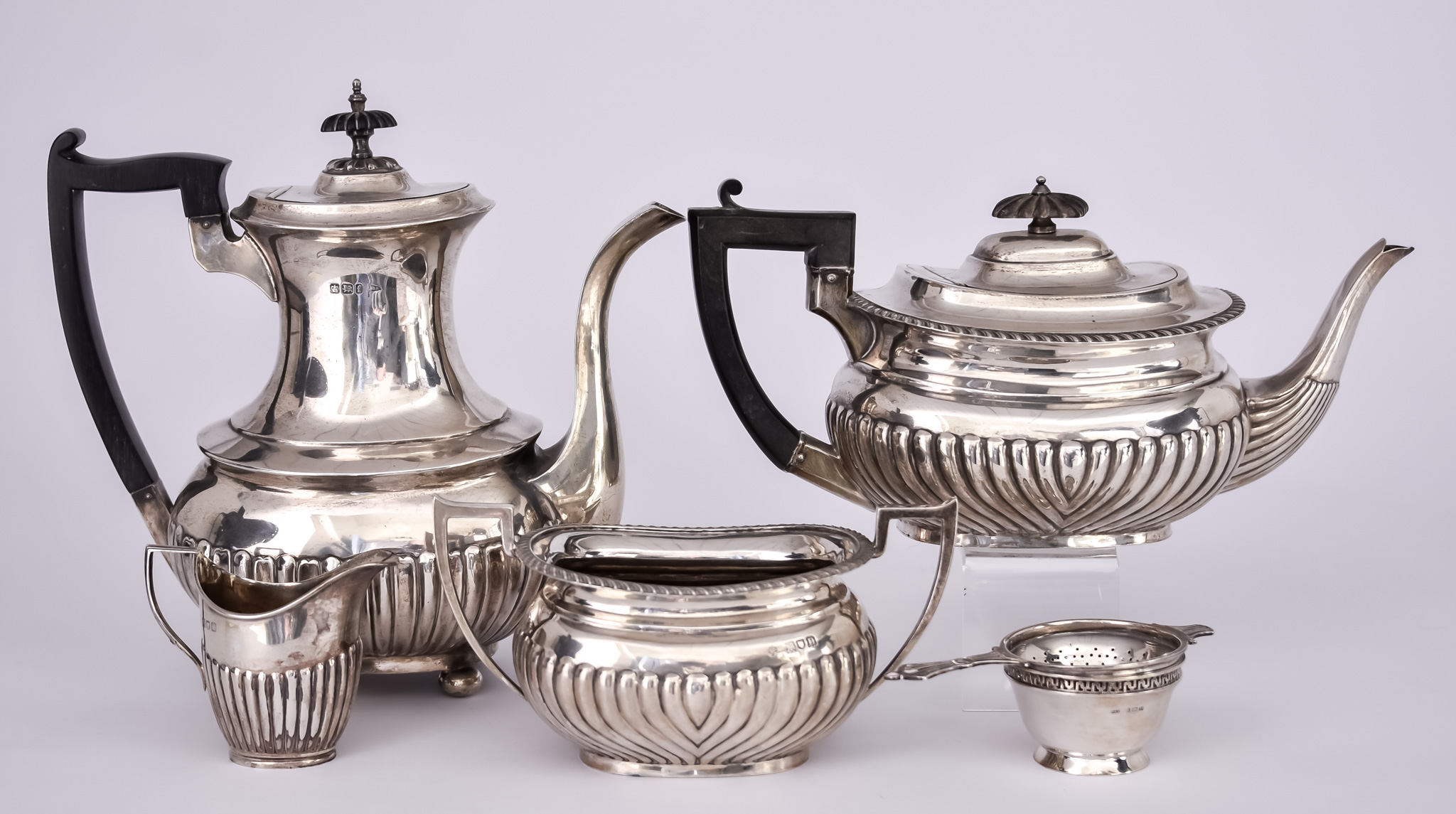 A Victorian/ Edward VII Harlequin Silver Tea and Coffee Set and a Tea Strainer, the set by various