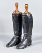 A Pair of Black Leather Riding Boots, Early 20th Century, with a pair of wooden boot trees