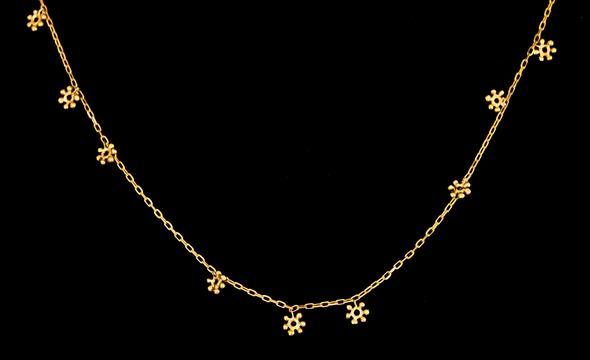 A 14ct Longuard Chain, with suspended snow flakes, retailed by Liberty, 960mm overall, total gross