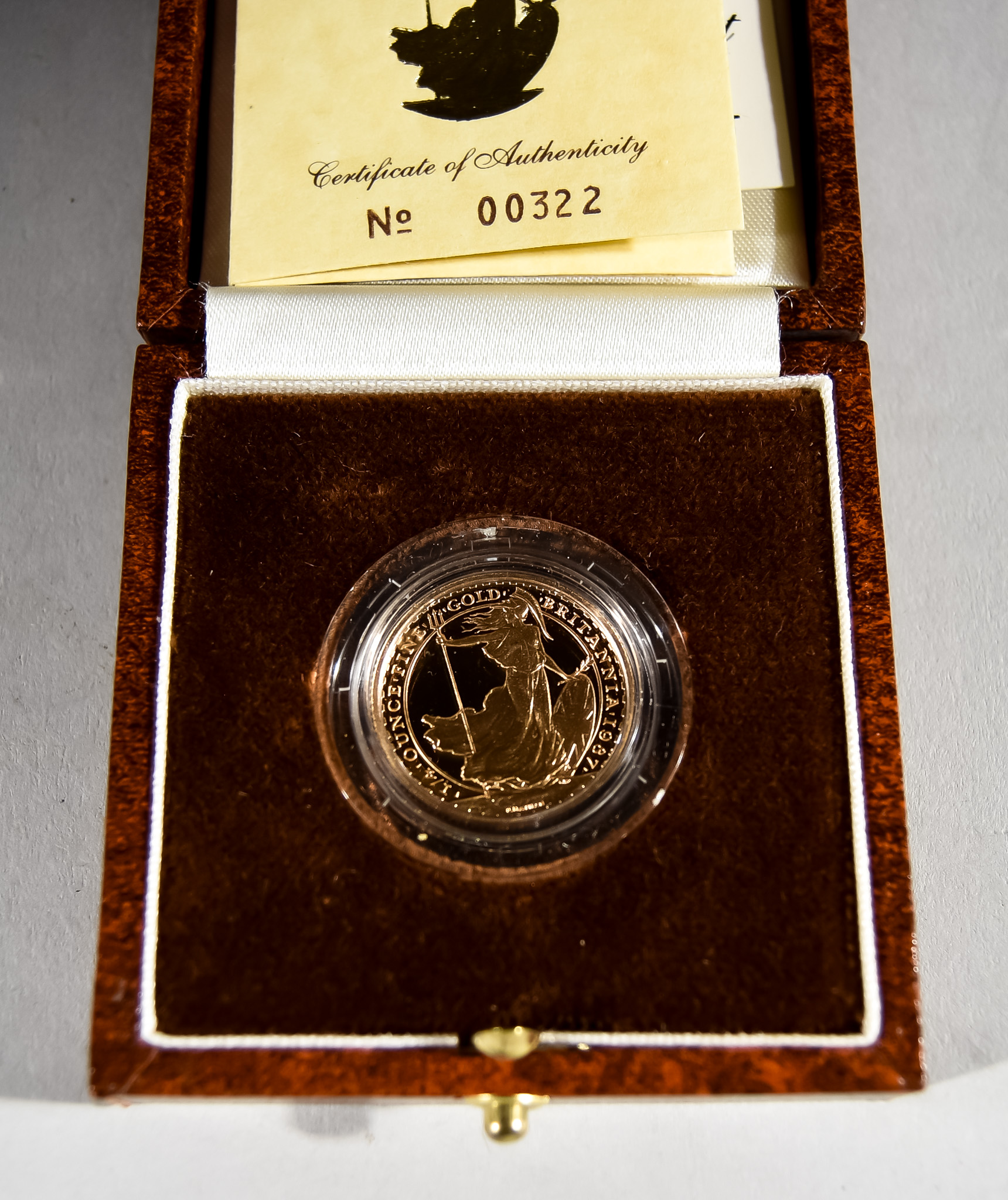 An Elizabeth II Britannia Quarter Ounce Proof Coin, 1987, in Royal Mint presentation case with