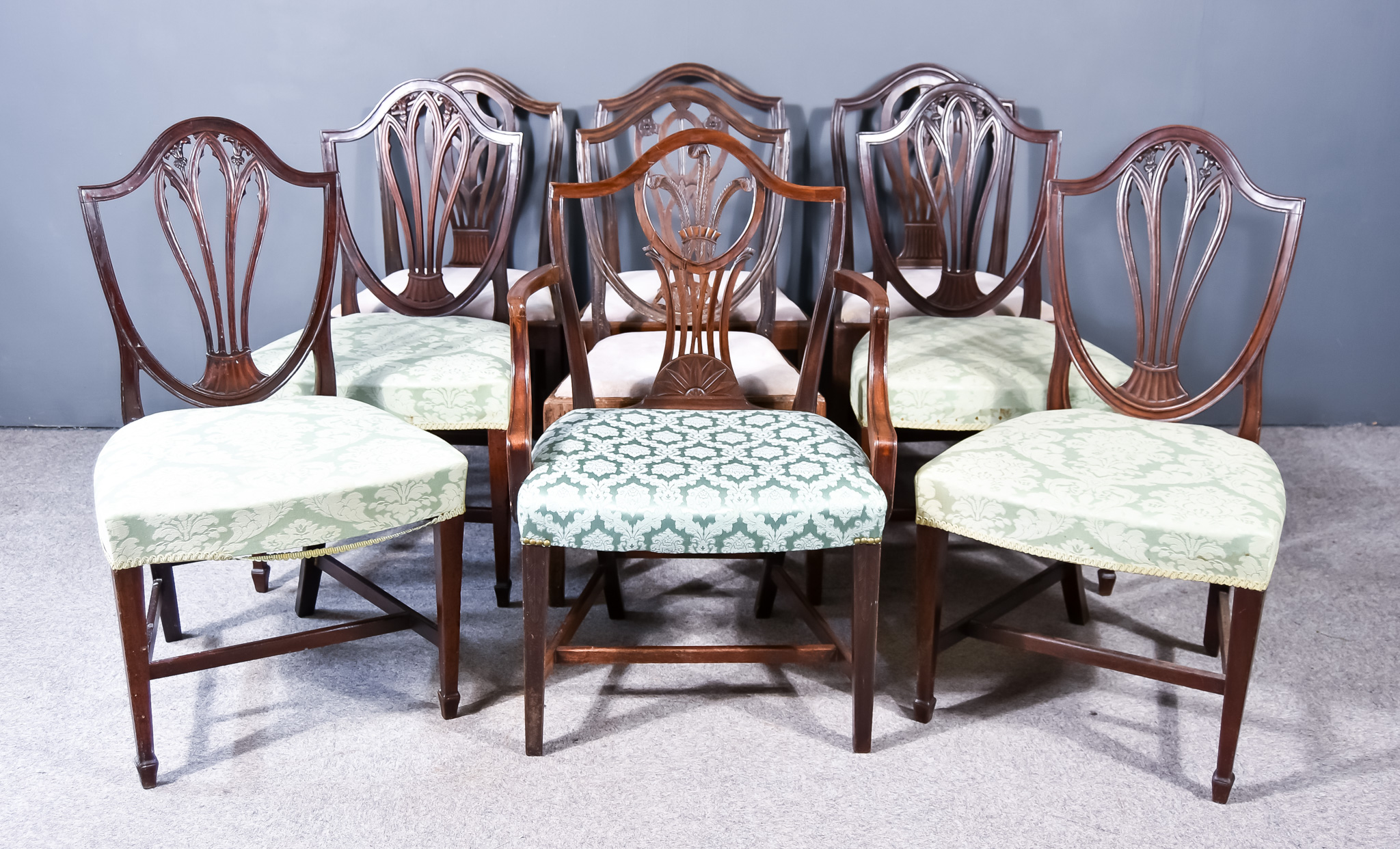 A Harlequin Set of Nine Late 18th Century Dining Chairs, of "Hepplewhite" design, the shaped back