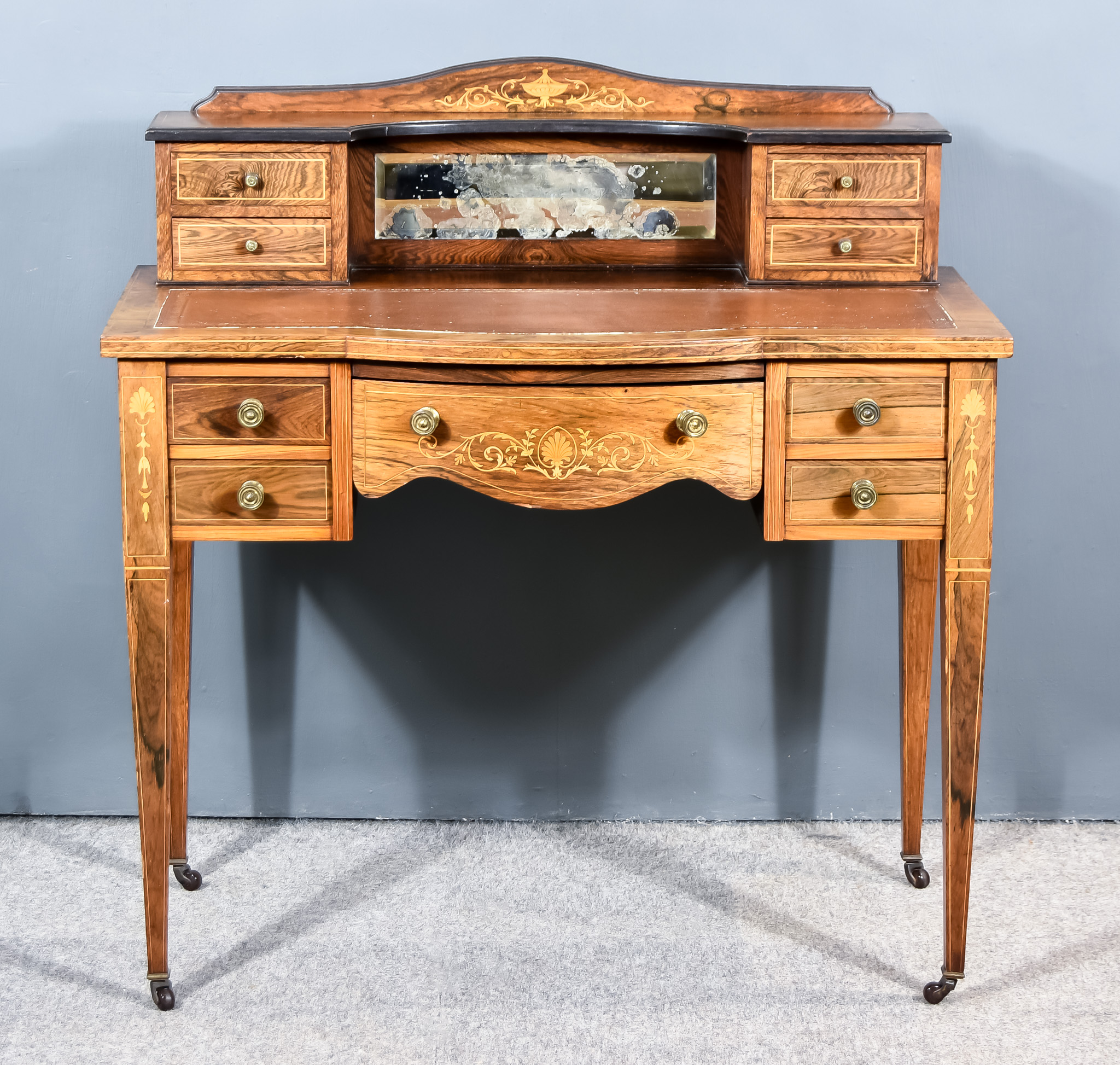 An Edwardian Inlaid Rosewood Writing Table, the superstructure with four drawers, the base fitted