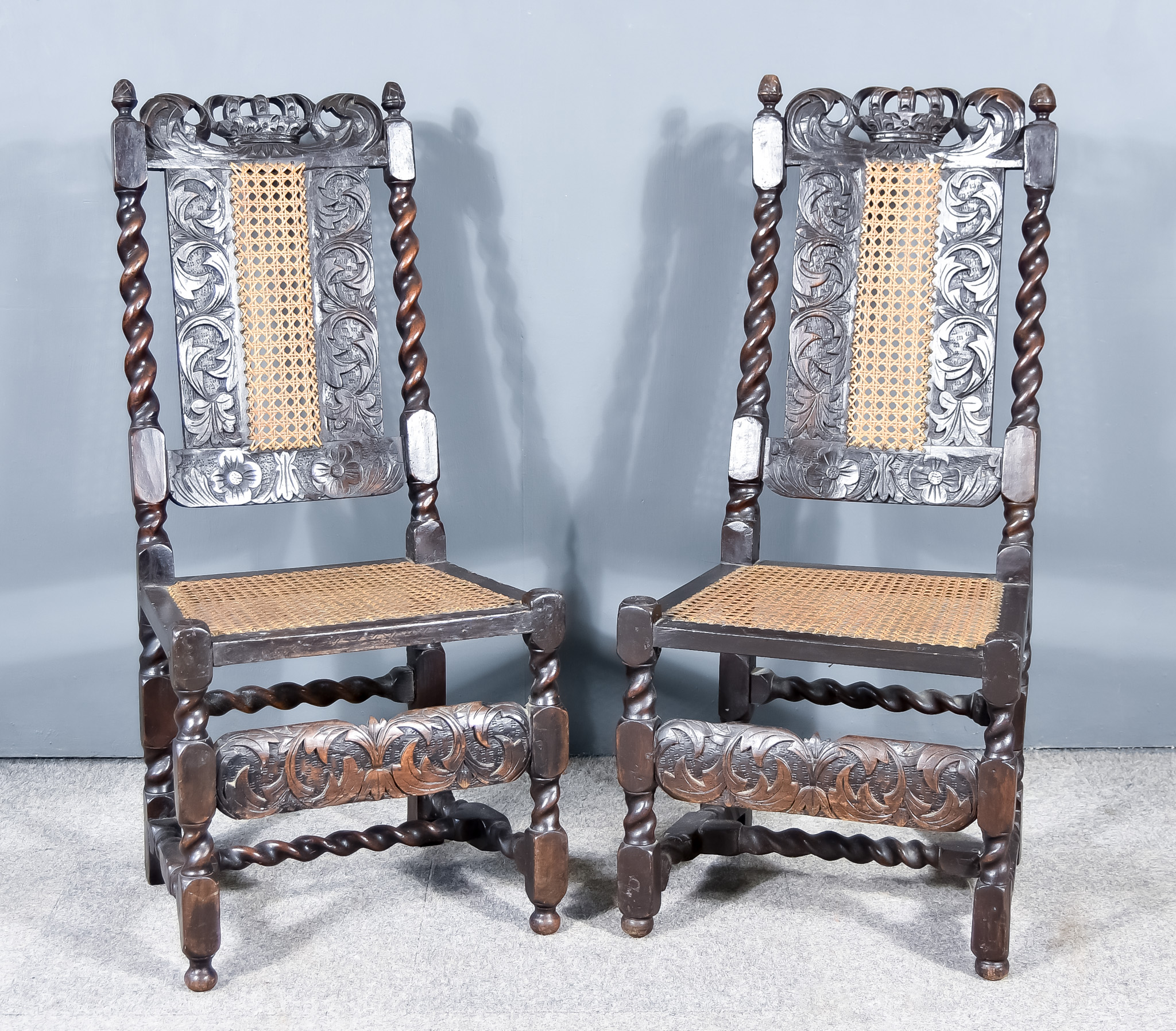 A Pair of Oak Dining Chairs of 17th Century Design, the crests carved with crowns, the backs and