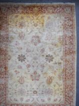 An Early 20th Century Ziegler Carpet, woven in muted colours, the field filled with trailing leaf