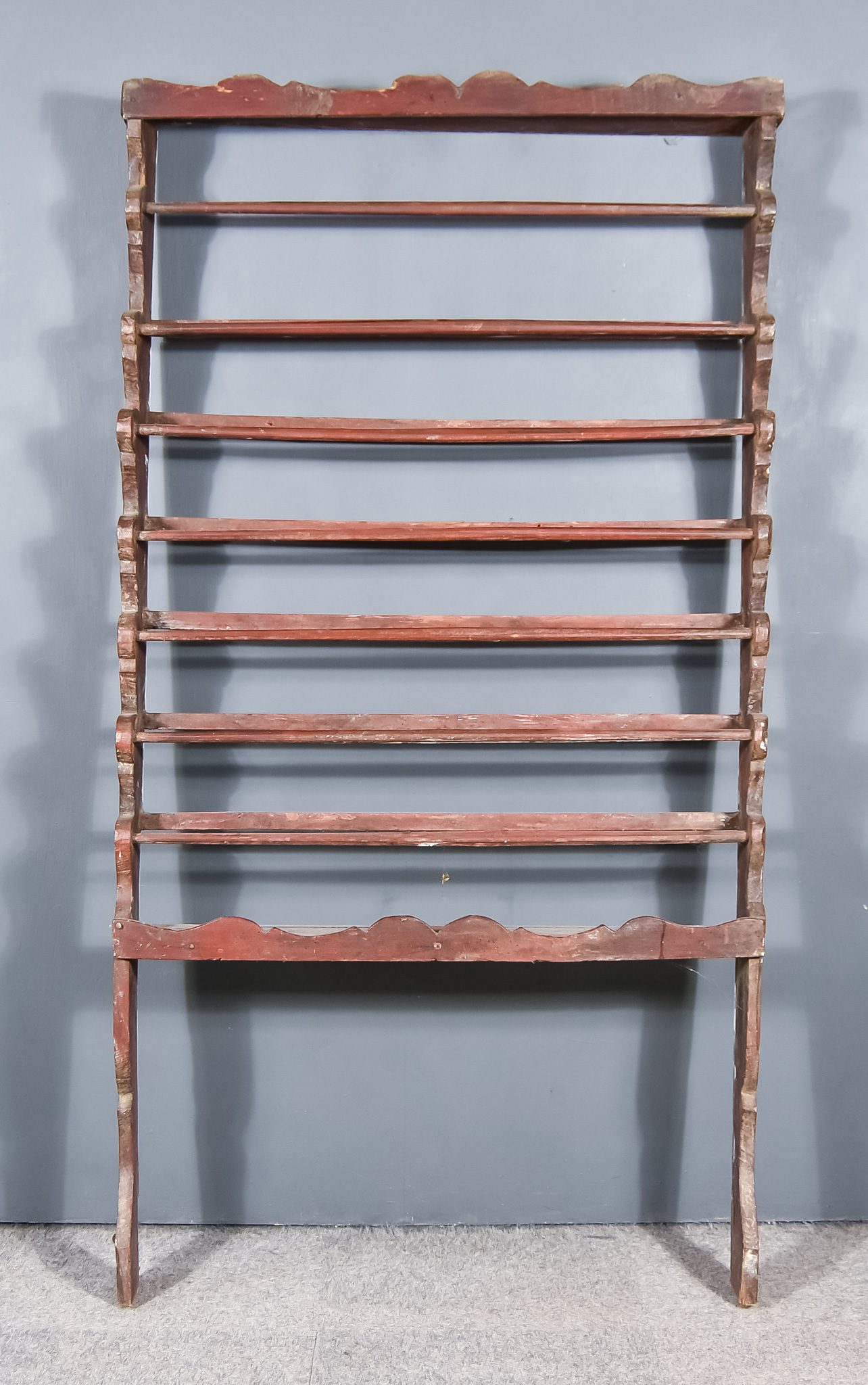 A Late 18th/Early 19th Century Painted Pine Seven Tier Rail, with shaped cresting and sides, and