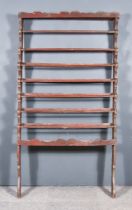 A Late 18th/Early 19th Century Painted Pine Seven Tier Rail, with shaped cresting and sides, and