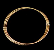 A 9ct Gold Hinged Bangle, two coloured, 55mm internal diameter, gross weight 6.8g The bangle