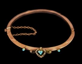 A 9ct Gold Stiff Bangle, set with a heart motif in seed pearls flanked by small turquoise stones,