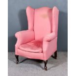 A Late 19th/ Early 20th Century Wing Back Armchair of "Georgian" Design, shaped back and out